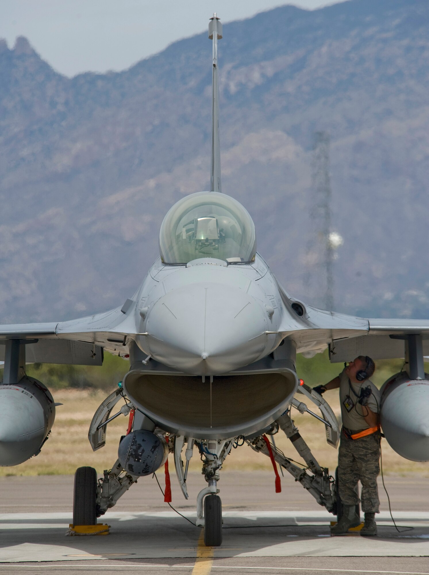 Senior Airman Adam Flood conducts pre-flight checks after engine start up April 24 at Davis-Monthan Air Force Base, Ariz. Airman Flood is assigned to the Texas Air National Guard’s 149th Fighter Wing in San Antonio and participating in Exercise Coronet Cactus. Airman Flood is an F-16 Fighting Falcon crew chief. (U.S. Air Force photo/Master Sgt. Jack Braden)