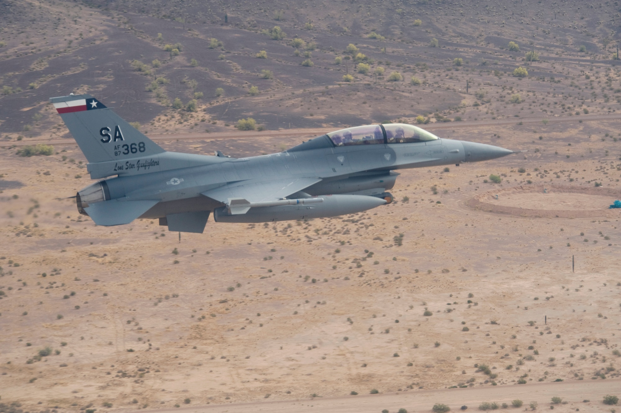 An instructor pilot with the Texas Air National Guard’s 149th Fighter Wing makes a low-level pass over the Barry Goldwater Bombing Range after completing an Exercise Coronet Cactus training mission April 24 near Tucson, Ariz.  The 149th Fighter Wing trains active duty F-16 pilots prior to assignment to their first duty station. (U.S. Air Force photo/Master Sgt. Jack Braden)