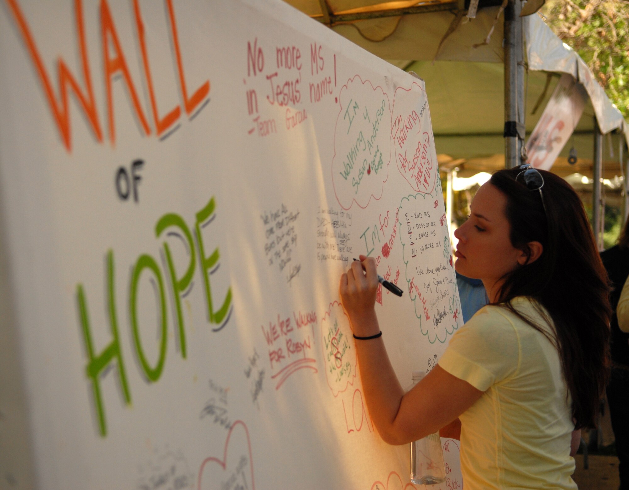 SAN LUIS OBISPO, Calif. -- In honor of her father, Airman 1st Class Laura Blanco, a 30th Medical Operations Squadron public health technician, writes a message on the Wall of Hope at the Walk for Multiple Sclerosis on April 26. Airman Blanco was the captain of a 15-member team that walked to raise money for research for multiple sclerosis. (U.S. Air Force photo/ Airman 1st Class Antoinette Lyons)