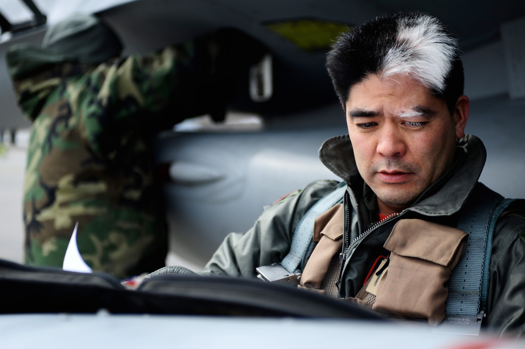 Lt. Col. Michael Kato, 124th Fighter Squadron. Des Moines, Iowa, goes over pre-flight inspection checklist during RED FLAG-Alaska 09-2, April 24, 2009, Eielson Air Force Base, Alaska.  This exercise provides unique opportunities to integrate various forces into joint, coalition and bilateral training from a simulated forward operating base.  (U.S. Air Force photo/Senior Airman Jonathan Snyder) (Released)
