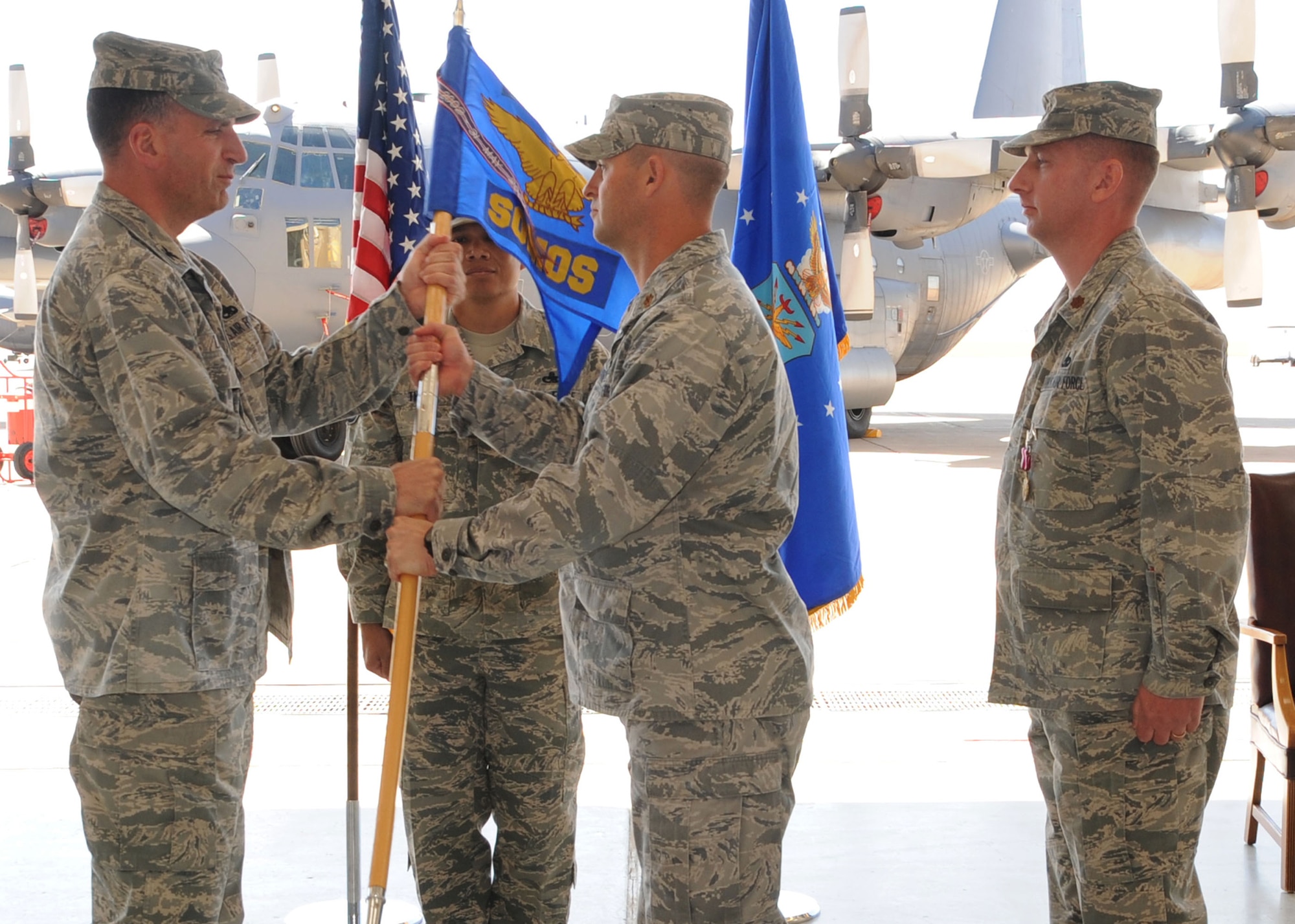 CANNON AIR FORCE BASE, N.M.-- (left) Col. Mark LaRose, 27th Special Operations Maintenance Group commander, presents the guidon and command of the 27th Special Operations Maintenance Operations Squadron to Maj. Ryan White in a change of command ceremony April 27. The outgoing commander is Maj. John Johnson who will take command of the 27th Special Operations Aircraft Maintenance Squadron. (U.S. Air Force photo by Airman 1st Class Maynelinne De La Cruz)