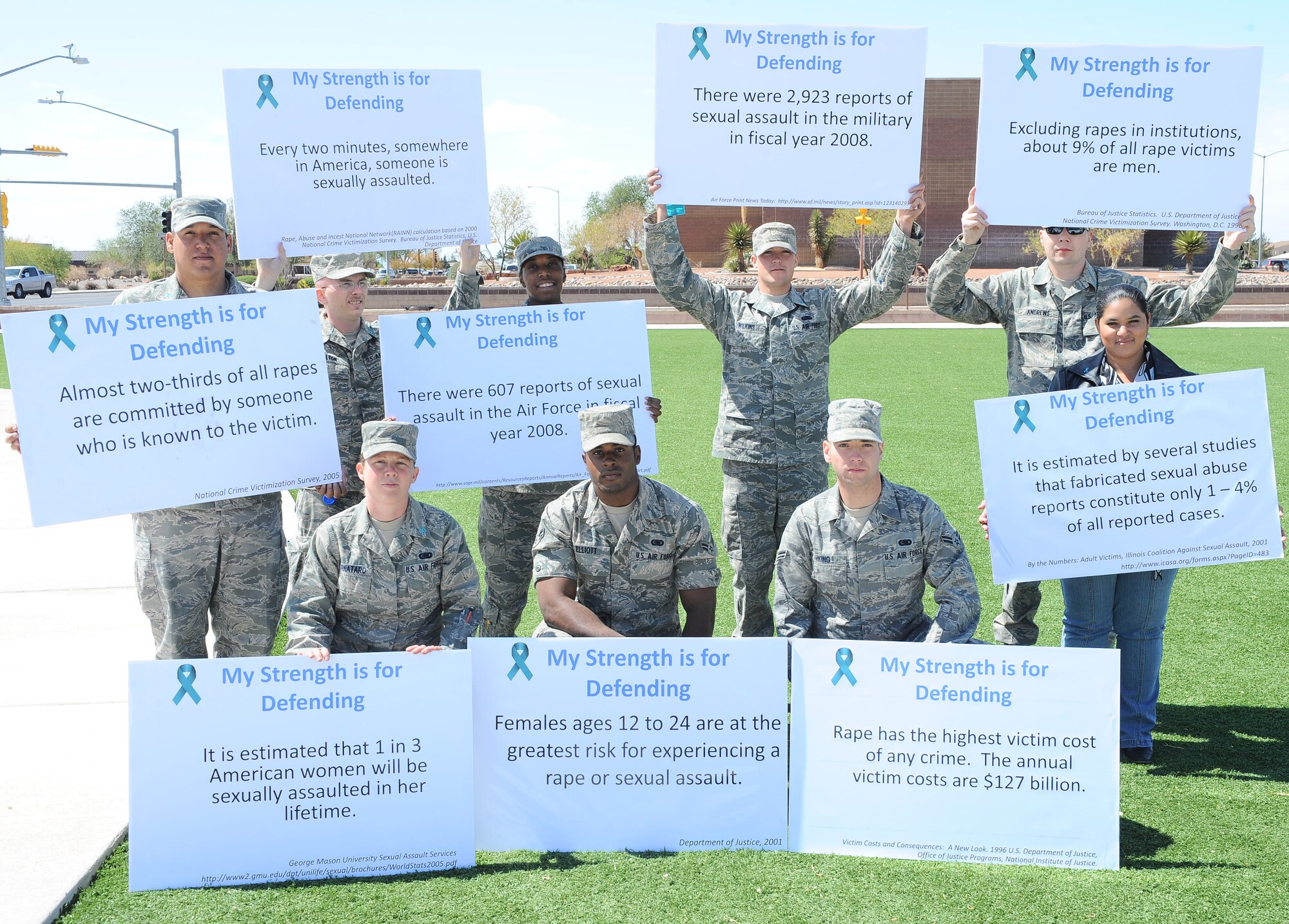 Volunteers involved in the "My Strength is for Defending" Walk for Sexual Assault Awareness hold up signs, April 17, after the event was completed. The volunteers taking part were: (left to right kneeling) Airman Francy Fornataro, Airman Darryal Elliot and Airman Lucas King; (standing left to right) Airman Jason Landry, Airman Steven Dalton, Airman Shynita Dunn, Airman Tyler Wilkins, Airman Timothy Andrews and Myrna Acosta. (U.S. Air Force photo/ Airman 1st Class DeAndre Curtiss)
