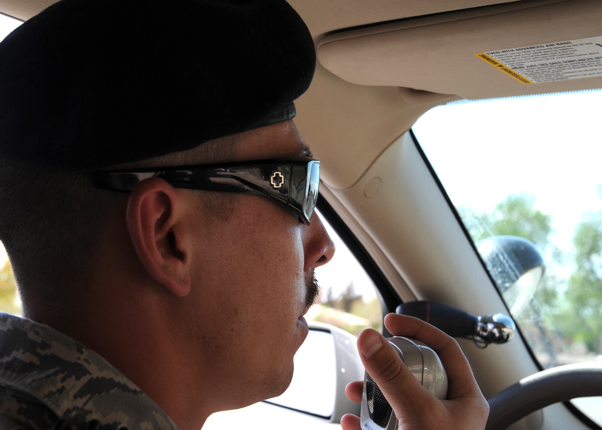 Staff Sgt. David Hughes, a patrolman with 49th Security Forces Squadron, radios in license plate information after pulling over a speeding vehicle, April 23, at Holloman Air Force Base, N.M. The times of operation for the school zones on Holloman are between 7:30 a.m. to 8:15 a.m. and 2:30 p.m. to 3:15 p.m. The last day of school for Holloman students is May 22. (U.S. Air Force photo/Senior Airman Rachel Kocin)