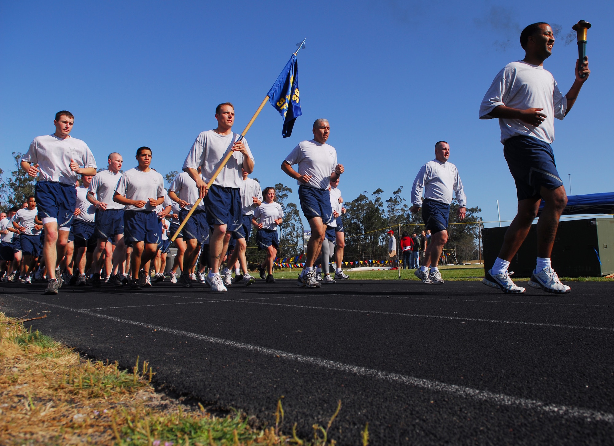 VANDENBERG AIR FORCE BASE, Calif. – Airmen from the 30th Security Forces Squadron run a torch to the 2009 Special Olympics held at the base track April 25. During the event's opening ceremonies, the torch was carried from Vandenberg's main gate to the base track to kick off the day’s events presented by Northern Santa Barbara County. (U.S. Air Force photo / Senior Airman Christopher Hubenthal)