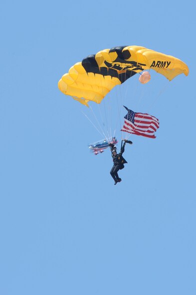 A member of the U.S. Army Golden Knights soars through the sky as part of the opening ceremony of the Wings Over Wayne Air Show during the National Anthem at Seymour Johnson Air Force Base N.C., April 25, 2009. The team has performed more than 15,000 shows in 48 countries and all 50 states since they formed in 1959. (U.S. Air Force photo by Airman 1st Class Whitney Lambert)