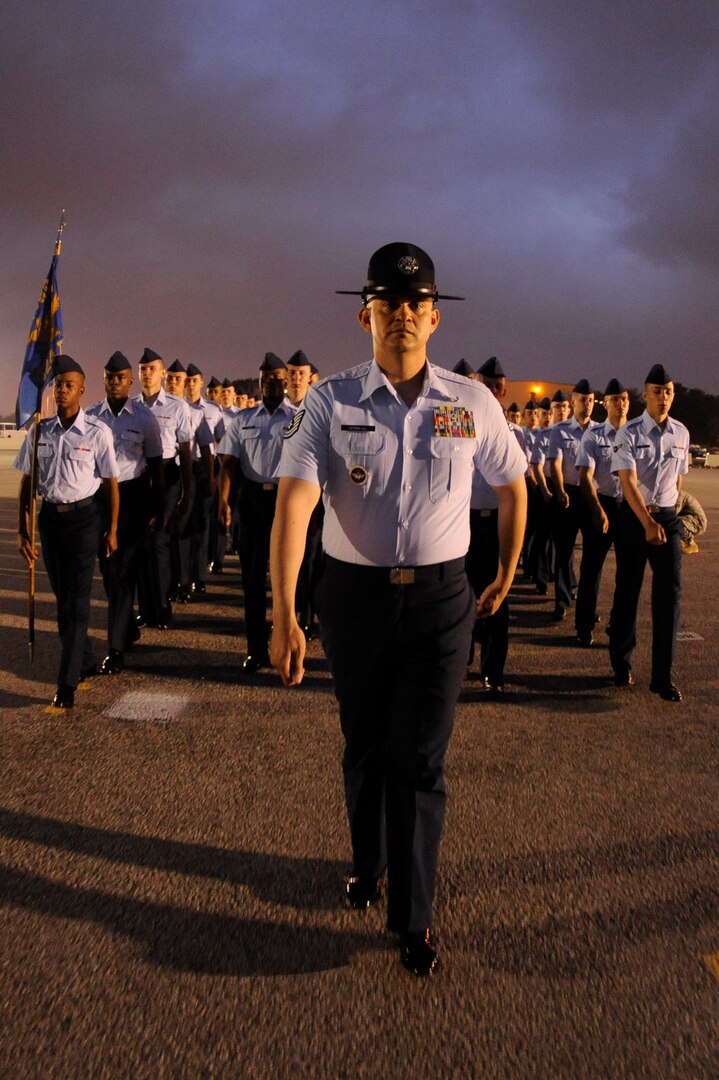 Tech. Sgt. Carlos Carbajal marches his flight of basic trainees toward the parade ground at Lackland Air Force Base, Texas, April 24 for their graduation ceremony.  Sergeant Carbajal is a military training instructor assigned to the 324th Training Squadron.  (U.S. Air Force photo/Staff Sgt. Desiree N. Palacios)