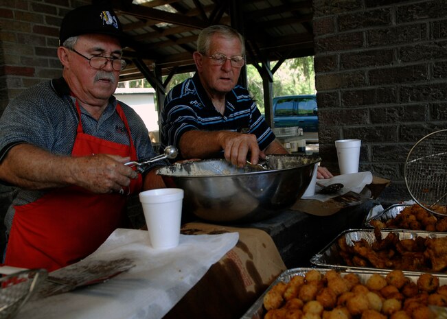 Retired Chief Master Sgts. Wilson Thomas and Robert Adams make hush puppies for the Chief's fish fry held at the picnic grounds here April 24. The Chief's group sold 500 tickets to Charleston members. (U.S. Air Force photo/Senior Airman Katie Gieratz)
