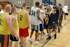 Team members of the 437th Force Support Squadron and 437th Civil Engineer Squadron congratulate each other on a well-played game at the end of the base intramural basketball championship game at the Fitness and Sports Center here April 23. The 437 CES defeated the 437 FSS 47-31 for the base championship. (U.S. Air Force photo/Staff Sgt. Marie Cassetty)(RELEASED)