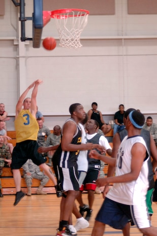 Morgan Jarrett shoots a two-point jump shot over the 437th Force Support Squadron defenders during the base intramural basketball championship game at the Fitness and Sports Center here April 23. Jarrett was the top scorer for his team with a total of 13 points. The 437th Civil Engineer Squadron defeated the 437 FSS 47-31. Jarrett is assigned to the 437 CES. (U.S. Air Force photo/Staff Sgt. Marie Cassetty)(RELEASED)