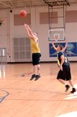 Morgan Jarrett shoots a three-point jump shot during the base intramural basketball championship game at the Fitness and Sports Center here April 23. The 437th Civil Engineer Squadron defeated the 437th Force Support Squadron 47-31.This is the second base championship for the 437 CES since 2004. Jarrett is assigned to the 437 CES. (U.S. Air Force photo/Staff Sgt. Marie Cassetty) (RELEASED)