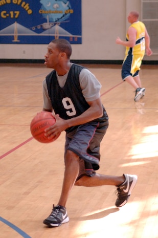 Kendrick Ward prepares to pass the ball during the base intramural basketball championship game at the Fitness and Sports Center here April 23. The 437th Civil Engineer Squadron defeated the 437th Force Support Squadron 47-31 for the base championship. Ward is assigned to the 437 FSS. (U.S. Air Force photo/Staff Sgt. Marie Cassetty)(RELEASED)