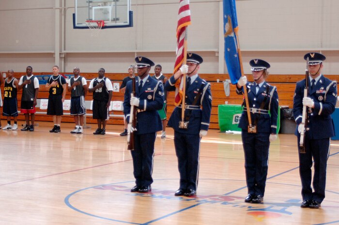 The base honor guard post the colors before the start of the intramural basketball championship game at the Fitness and Sports Center here April 23. The 437th Force Support Squadron and the 437th Civil Engineer Squadron played for the base championship. The 437 CES defeated the 437 FSS 47-31. (U.S. Air Force photo/Staff Sgt. Marie Cassetty)(RELEASED)