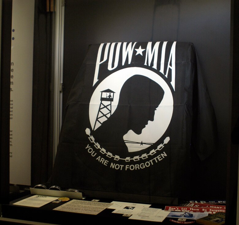 DAYTON, Ohio - Articles in this display include a pre-addressed postcard to Ton Duc Thang, President of North Vietnam, to enlist his support in determining the fate of Lt. Larry Potts. Despite repeated appeals like this one, North Vietnam remained unsympathetic. POW/MIA bracelets and buttons reminded the public of the plight of prisoners in Southeast Asia. Many people wore the bracelets until the fate of their POW/MIA was resolved—and then sent the bracelet to the returned POW if he was alive. Also included are articles used as late as 1975 by the Volunteers for POW/MIAs of Dayton, Ohio. The black flag is the official POW/MIA flag, which is flown six times a year at designated federal sites. It was designed in 1971 by Newt Heisley, a WWII pilot and advertising artist who never profited from the uncopyrighted design. (U.S. Air Force photo)