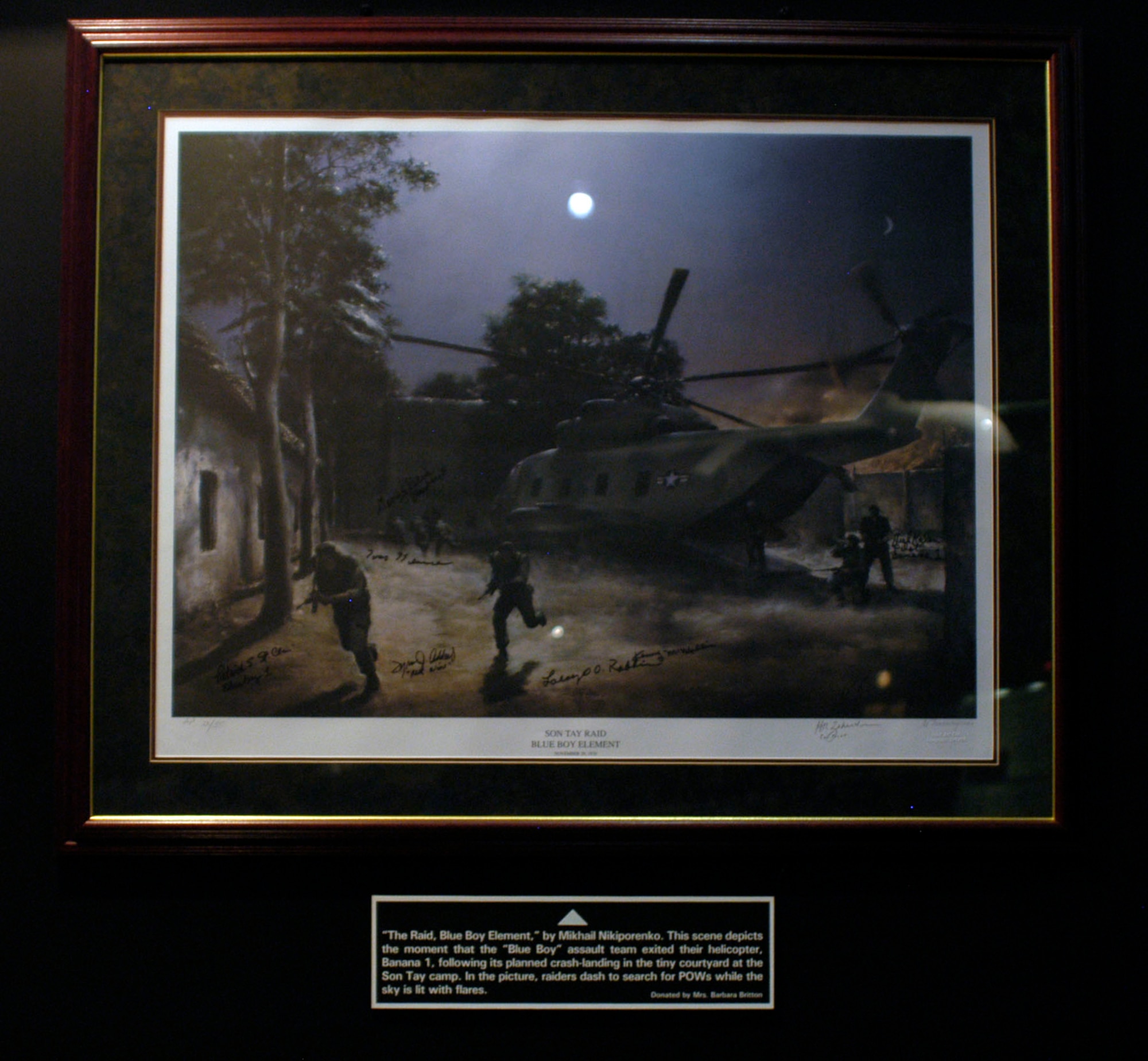 DAYTON, Ohio - “The Raid, Blue Boy Element,” by Mikhail Nikiporenko. This scene depicts the moment that the “Blue Boy” assault team exited their helicopter, Banana 1, following its planned crash-landing in the tiny courtyard at the Son Tay camp. In the picture, raiders dash to search for POWs while the sky is lit with flares.This framed lithograph is on display in the Return with Honor: American Prisoners of War in Southeast Asia exhibit in the Southeast Asia War Gallery at the National Museum of the U.S. Air Force. (U.S. Air Force photo)