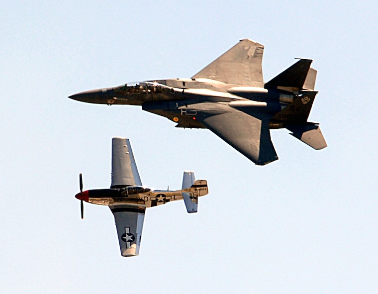 Captain Phil "Ritz" Smith, 4th Operations Group F-15E Strike Eagle demonstration team, flies in close formation with the P-51 Mustang "Glamorous Gal," flown by retired Capt. Dale "Snort" Snodgrass at Seymour Johnson Air Force Base, N.C., April 26, 2009.  The U.S. Air Force Heritage flight was established in 1997 to commemorate the Air Force's 50th anniversary and display the evolution of airpower.  (U.S. Air Force Photo by 2nd Lt. Matthew D. Schroff)