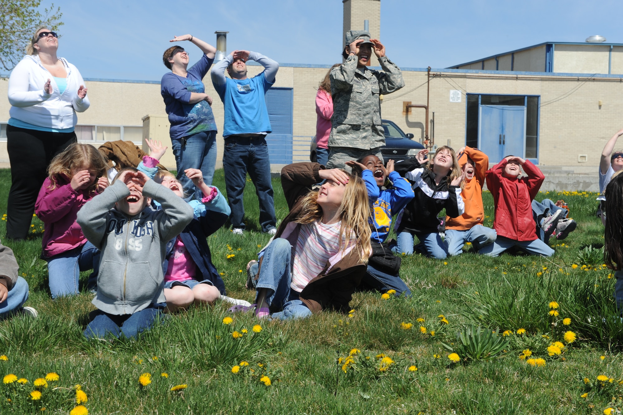 MOUNTAIN HOME AIR FORCE BASE, Idaho -- Volunteers and second grade students from the base primary school watch as rockets they built are launched in front of the school April 24. Students learned the fundamentals of rocketry, and then put the lesson to use by building rockets and launching them in front of the school. The event was part of the school’s annual science day event that included hands-on lessons in various scientific fields as well as guest speakers from the 366th Medical Group and the Bureau of Land Management. (U.S. Air Force photo by Airman 1st Class Debbie Lockhart)