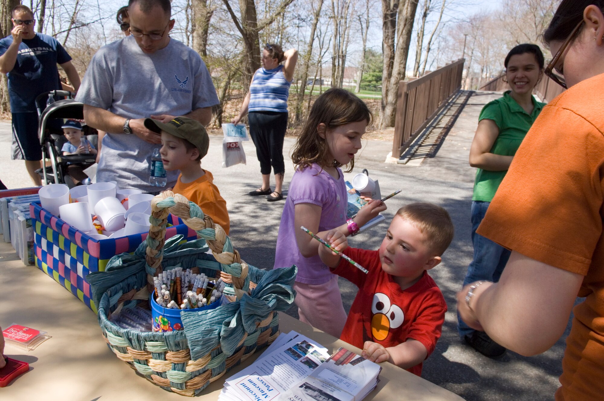HANSCOM AIR FORCE BASE, Mass. – Families stop to pick up items at one of the informational booths set up at the Walk and Talk event at Castle Park on April 25. The event was part of the base’s Month of the Military Child celebrations. (U.S. Air Force photo by Rick Berry) 