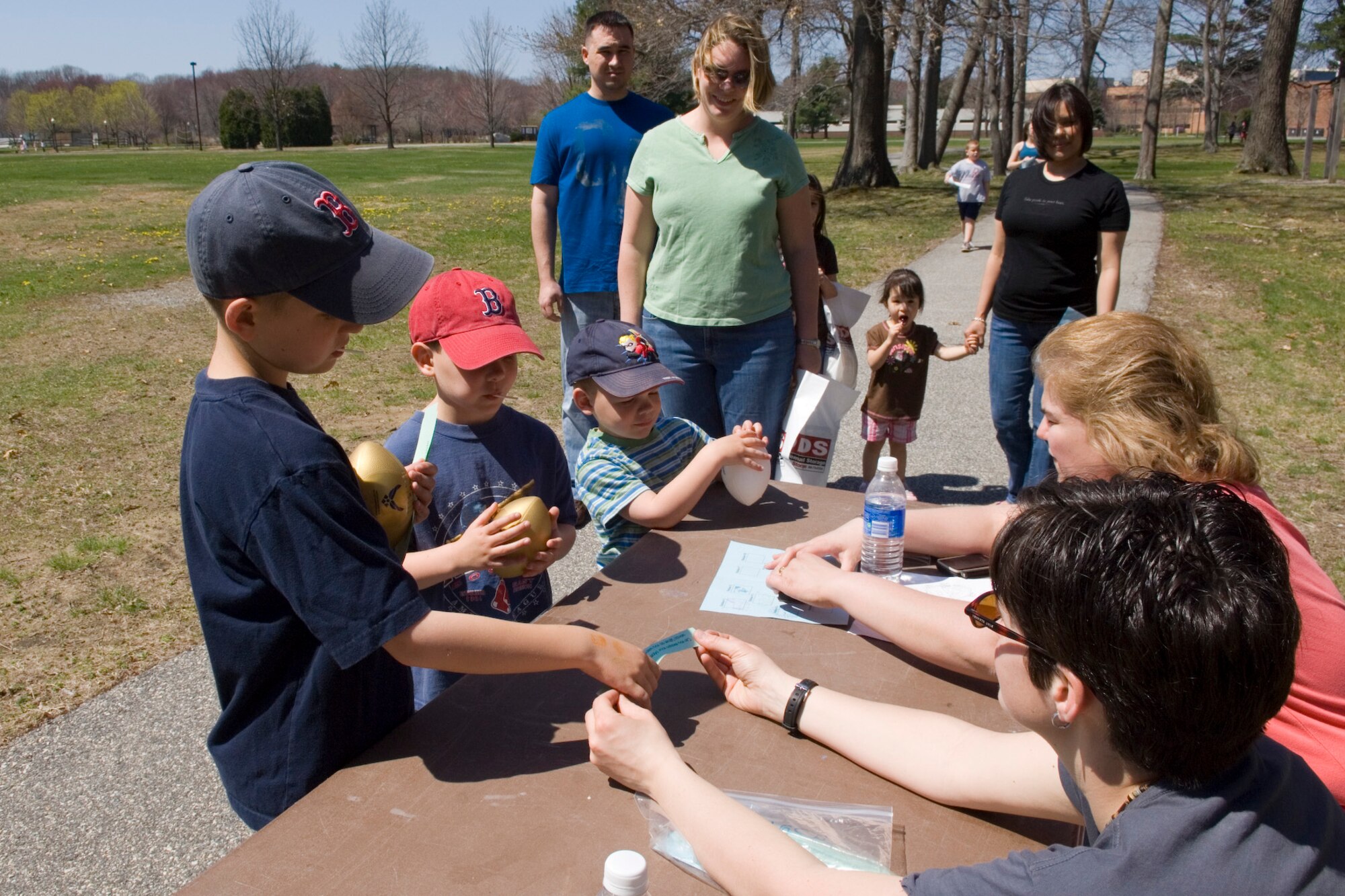 HANSCOM AIR FORCE BASE, Mass. – Members of the 66th Services Squadron, Nicole Picariello and Carmen Aguiar, run one of the activity tables set up during the Walk and Talk event at Castle Park on April 25. Families from across the base took part in the family event celebrating the Month of the Military Child. (U.S. Air Force photo by Rick Berry)