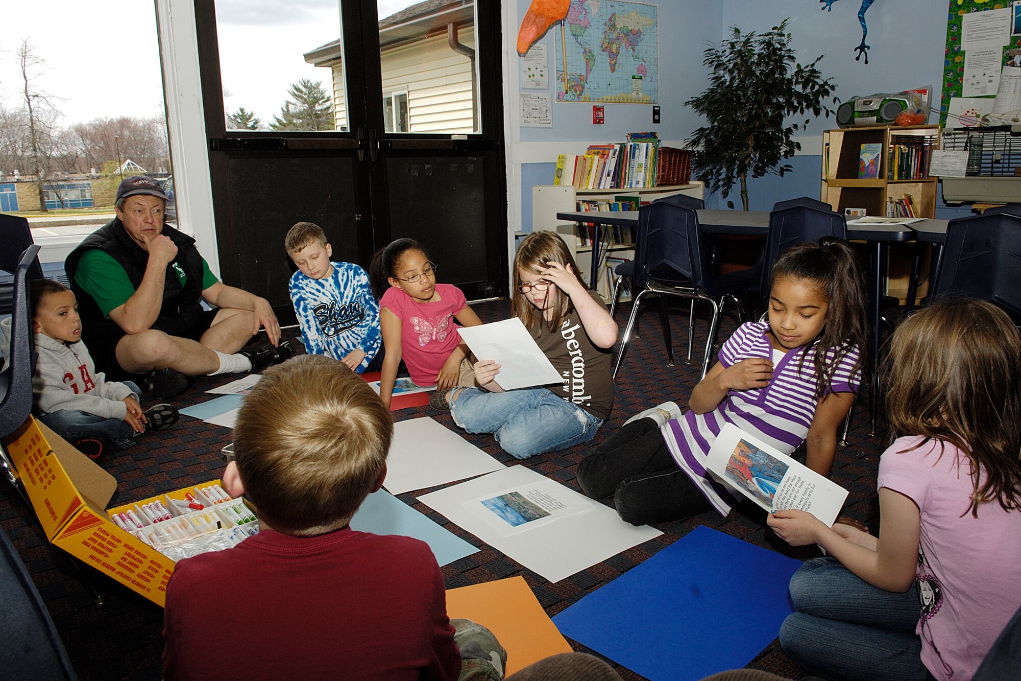 HANSCOM AIR FORCE BASE, Mass. – Children enrolled in the Hanscom School Age Program talk with their teacher, Greg Leschishin, about malaria and its impact on countries around the world particularly African nations. The activity was part of the Boys and Girls Club of America’s Malaria Prevention Campaign aimed at educating and encouraging young people to get involved in helping to solve problems in their communities and around the world.  (U.S. Air Force photo by Linda LaBonte Britt) 