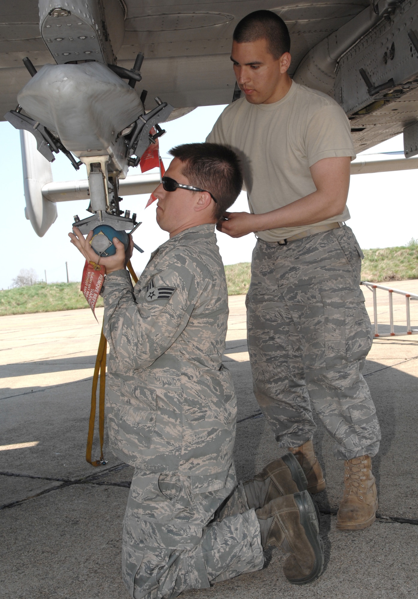 Airman John Medina assits Senior Airman Ryan Wooley in loading a practice bomb onto an A-10 Thunderbolt II preparing to depart on a training missionApril 16 at Bezmer Air Base, Bulgaria. A maintenance squadron team deployed to Bezmer AB to support a U.S. and Bulgarian air forces training exercise. Airmen Medina and Wooley are 52nd Aircraft Maintenance Squadron weapons load crewmembers. (U.S. Air Force photo/Master Sgt. Bill Gomez) 
