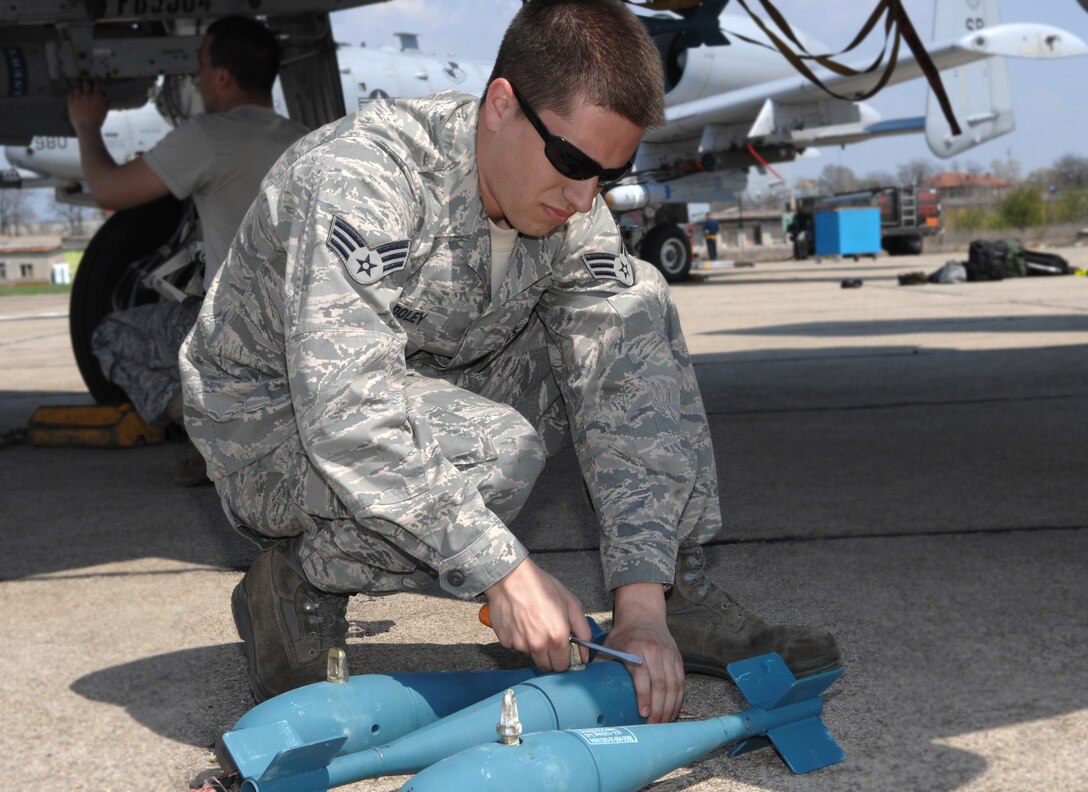 Senior Airman Ryan Wooley prepares practice bombs for loading onto an A-10 Thunderbolt II prior to a training mission April 16 at Bezmer Air Base, Bulgaria. A maintenance squadron team deployed to Bezmer AB to support a U.S. and Bulgarian air forces training exercise. Airman Wooley is a 52nd Aircraft Maintenance Squadron weapons load crewmember. (U.S. Air Force photo/Master Sgt. Bill Gomez) 