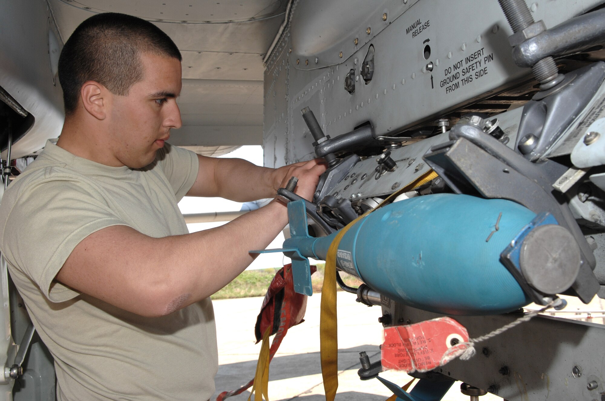 Airman John Medina secures a practice bomb onto an A-10 Thunderbolt II prior to a training mission April 16 at Bezmer Air Base, Bulgaria. A maintenance squadron team deployed to Bezmer AB to support Exercise Reunion April 2009. Airman Medina is a 52nd Aircraft Maintenance Squadron weapons load crewmember. (U.S. Air Force photo/Master Sgt. Bill Gomez) 
