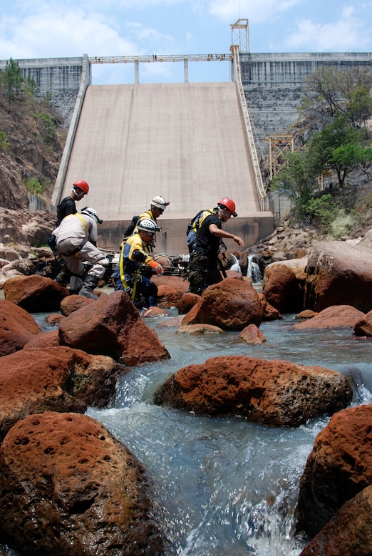 COMAYAGUA, Honduras - April 21, 2009) Firefighters from the Honduran National Fire Department and United Humanitarian Rescue carry a simulated fallen diver out of the water during an exercise scenario at Coyolar Dam here April 21.  The exercise scenario was part of FA-HUM ’09 an annual mission rehearsal exercise that tests and improves regional and national disaster (earthquake, volcano, and floods, pandemic) response capabilities within Central America and the Caribbean Basin.  (U.S. Army photo/Maj. Benjamin Garrett)  