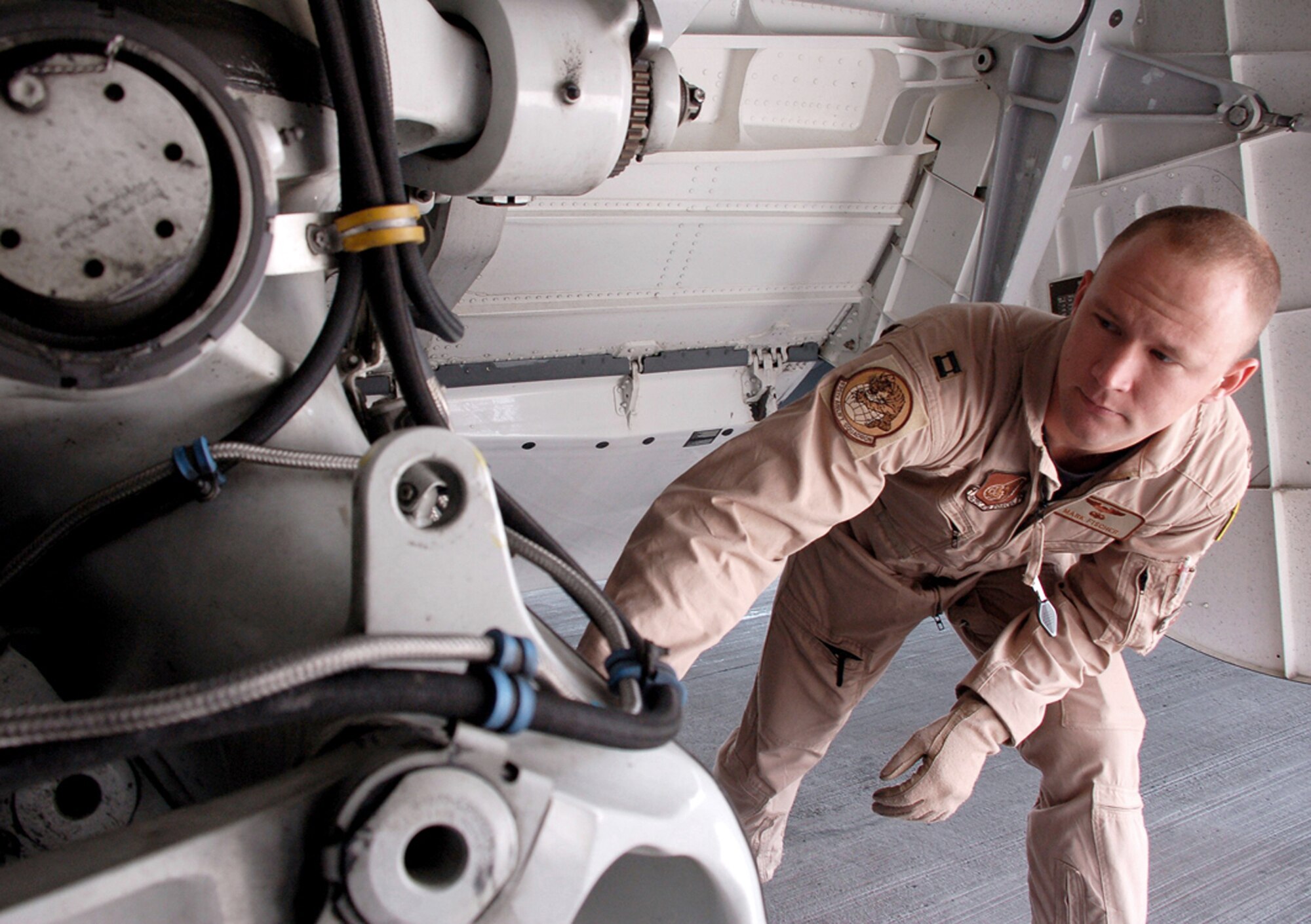 Capt. Mark Fischer conducts a final inspection April 18 on a C-17 Globemaster III he will fly to Afghanistan from Manas Air Base, Kyrgyzstan. During the past five weeks, aircrews have been flying three flights nearly every day in order to deliver needed supplies for the buildup of various bases supporting Operation Enduring Freedom. (U.S. Air Force photo/Tech. Sgt. Phyllis Hanson) 