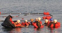 Staff Sgt. Jolene Koch, a medical technician with the 934 Aeromedical Evacuation Squadron practices entering and exiting the one-man life raft during water survival training in Key West Fla. (Air Force photo/Master Sgt. Kerry Bartlett)
