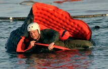 Lt. Coll. Mike Erickson, 96 airlift squadron pilot, practrices entering and exiting from the one-man life raft during water survival training at Key West, Fla. (Air Force photo/Master Sgt. Kerry Bartlett)