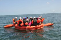 Students spent two hours in the 20-man life raft reviewing the contents of the survival kit which included making fresh water with the water purification system and setting up the canopy. (Air Force photo/Master Sgt. Kerry Bartlett)