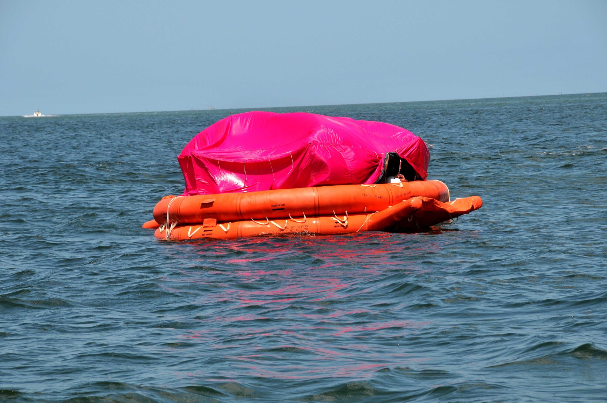 Students set up the protective canopy during the raft living phase of water survival training at Key West, Fla.(Air Force photo/Master Sgt. Kerry Bartlett)