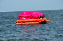 Students set up the protective canopy during the raft living phase of water survival training at Key West, Fla.(Air Force photo/Master Sgt. Kerry Bartlett)