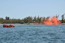 The luminescence of sea dye marker (foreground) is clearly visible, even at shallow angles, while smoke dissipates quickly during water survival training at Key West, Fla. (Air Force photo/Master Sgt. Kerry Bartlett)
