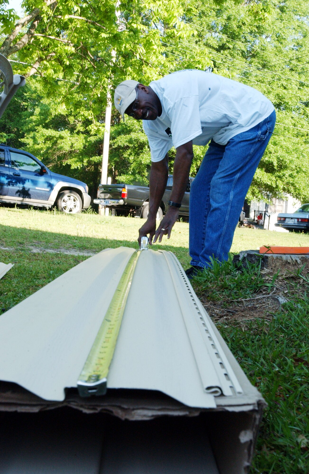 Don Tate, Rebuilding Together volunteer, measures siding Saturday. Rebuilding Together assists low-income homeowners with repairs they would not otherwise be able to accomplish on their own. More than 85 members, including family and friends, of Headquarters, Air Force Reserve Command, Robins Air Force Base, Ga., turned out for the event.