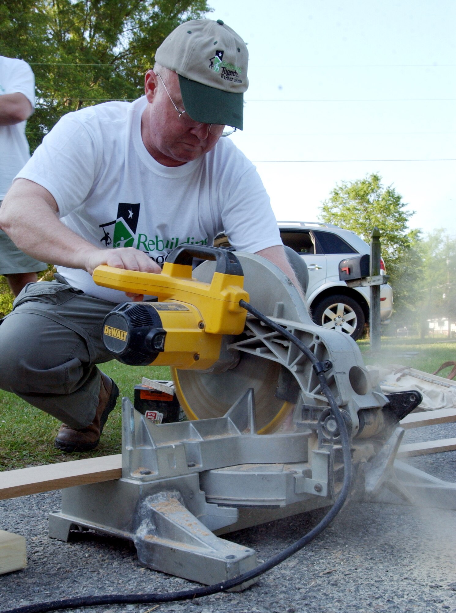 Maj. Gen. Hanferd "Rusty" J. Moen Jr., Director of Air, Space and Information Operations, Headquarters Air Force Reserve Command, Robins Air Force Base, Ga., cuts a piece of lumber Saturday. Rebuilding Together assists low-income homeowners with repairs they would not otherwise be able to accomplish on their own. More than 85 members, including family and friends, of Headquarters, Air Force Reserve Command, Robins Air Force Base, Ga., turned out for the event.