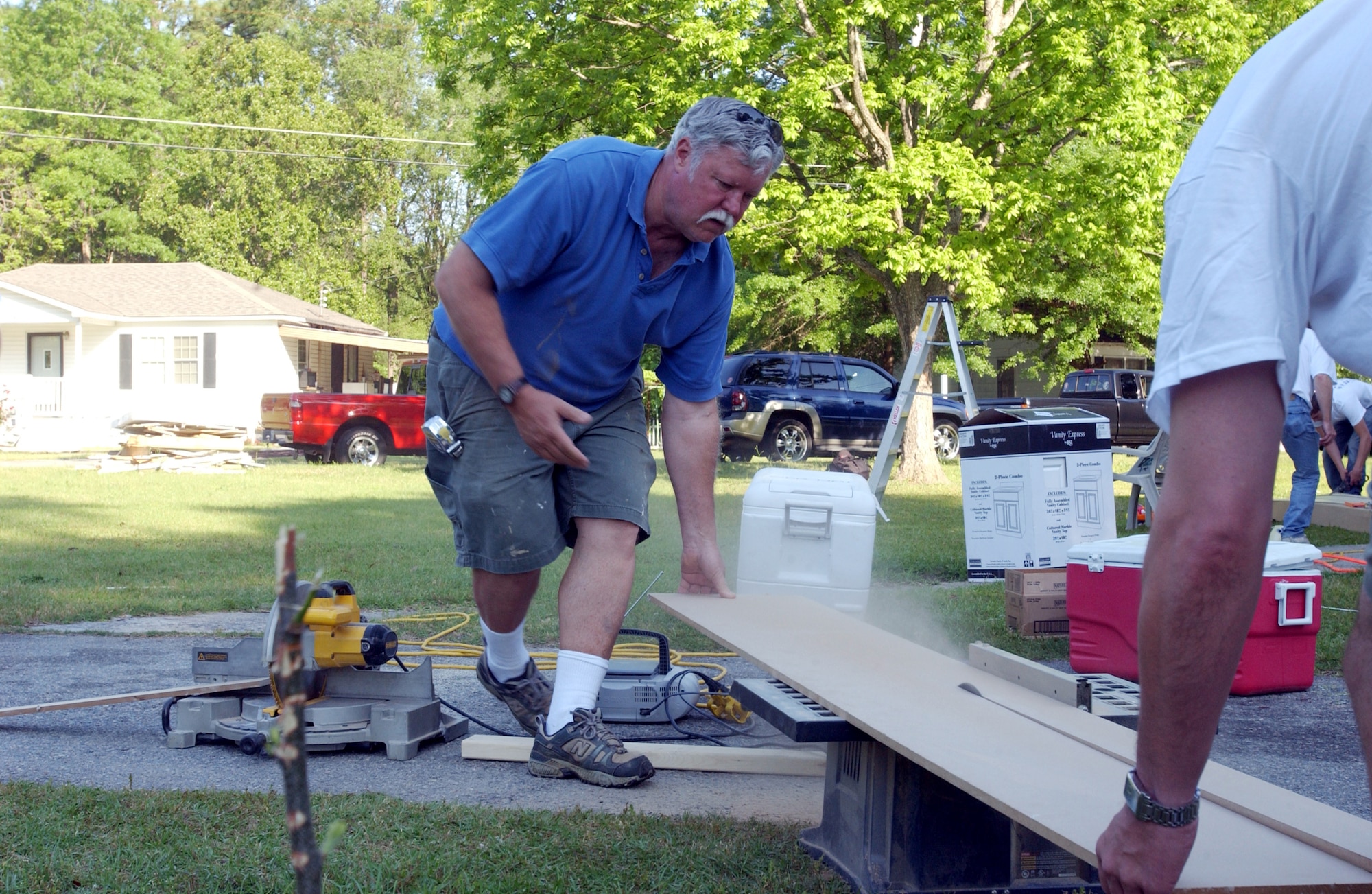 Harry Schonau, Rebuilding Together house captain, rips a piece of lumber Saturday morning. Rebuilding Together assists low-income homeowners with repairs they would not otherwise be able to accomplish on their own. More than 85 members, including family and friends, of Headquarters, Air Force Reserve Command, Robins Air Force Base, Ga., turned out for the event.