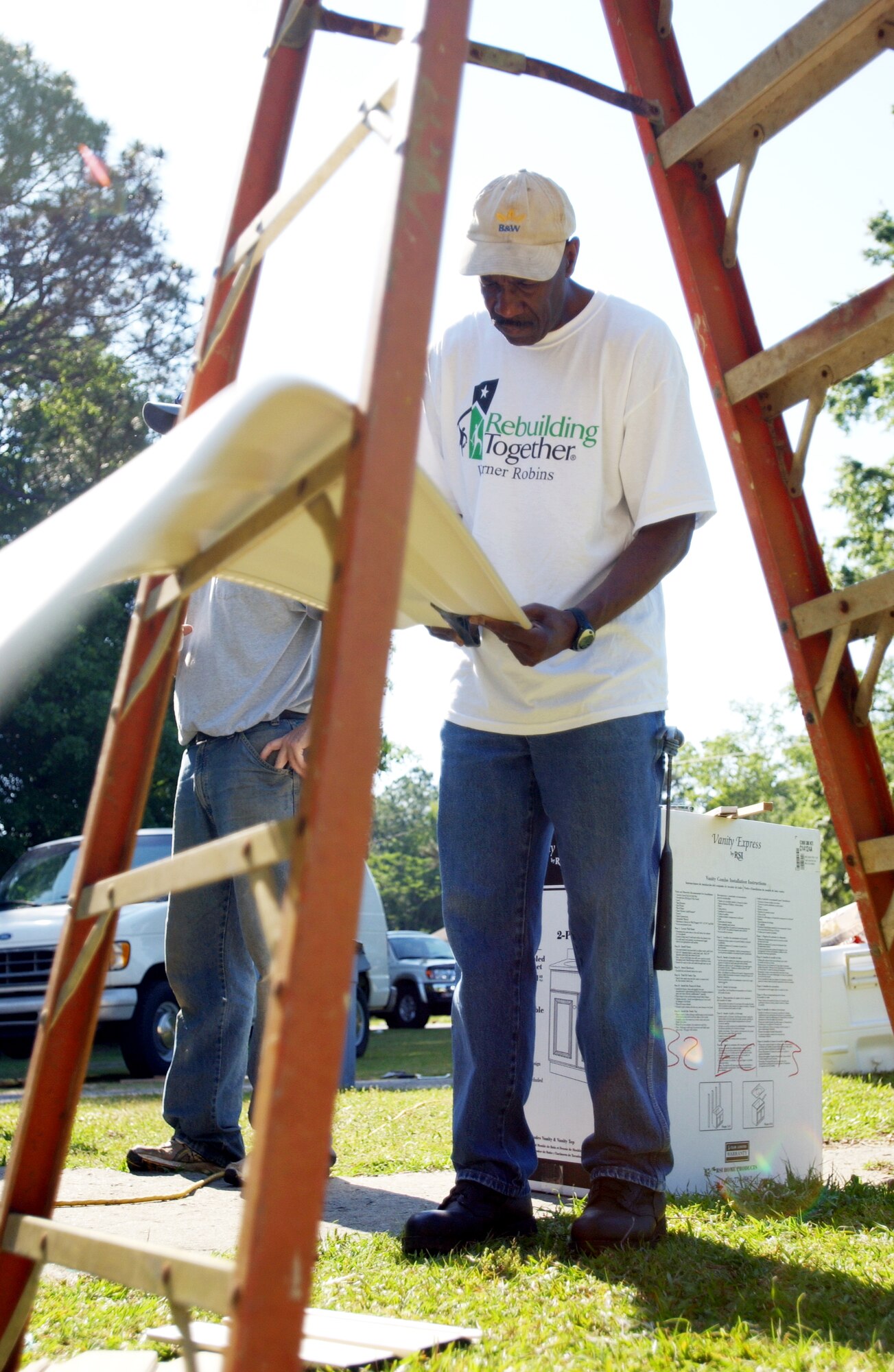 Don Tate, Rebuilding Together volunteer cuts siding to fit Saturday. Rebuilding Together assists low-income homeowners with repairs they would not otherwise be able to accomplish on their own. More than 85 members, including family and friends, of Headquarters, Air Force Reserve Command, Robins Air Force Base, Ga., turned out for the event.
