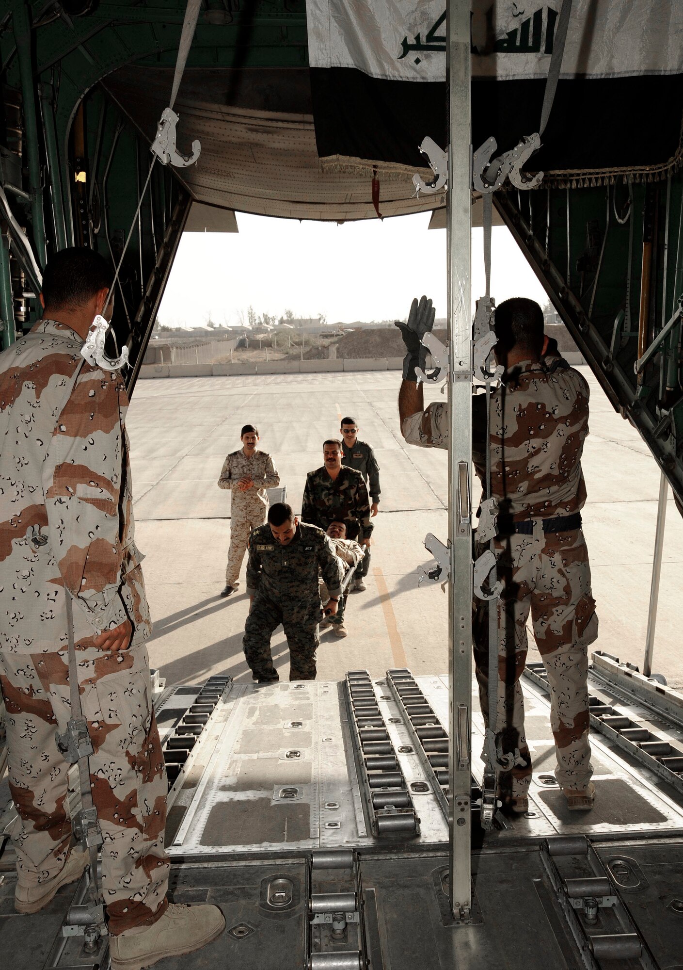 Iraqi air force Lt. Tahssen marshals in a litter during the aeromedical evacuation class for the Flight Surgeon Course April 20 at New al-Muthana Air Base, Iraq. The training is teaching the Iraqis how to convert a UH-1 Huey and a C-130 Hercules from a passenger transport to an aeromedical evacuation medevac transport. Lieutenant Tahssen is a flight nurse at the New al-Muthana Air Base clinic. (U.S. Air Force photo/Senior Airman Jacqueline Romero) 
