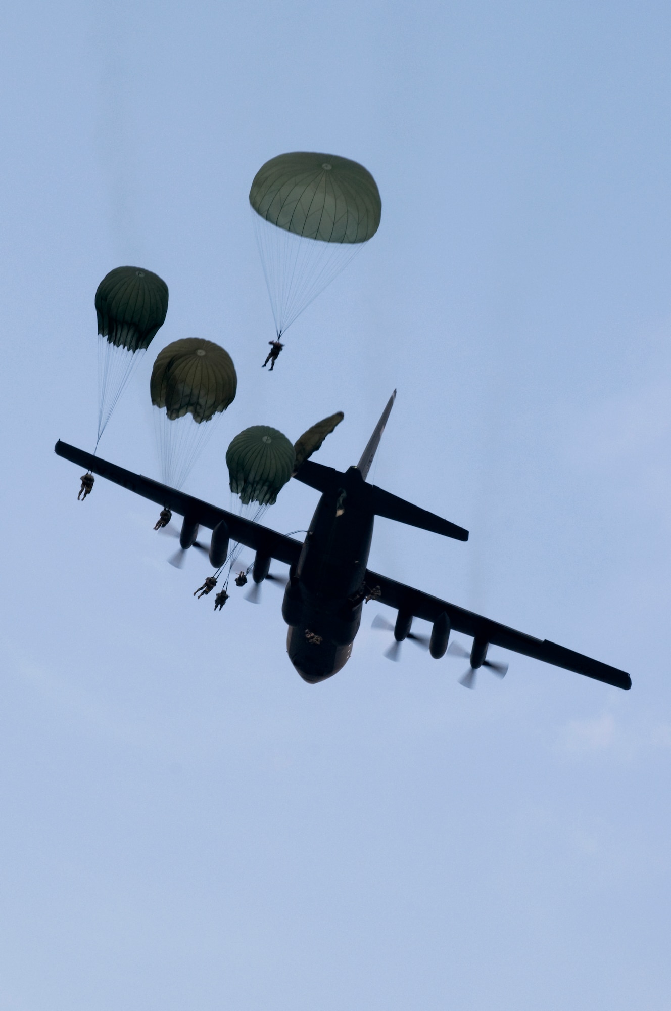 Members from the 173rd Airborne Brigade Combat Team drop out of a C-130E Hercules, April 22, 2009, Grafenwoehr Army Airfield, Germany. This is the last large combat training drop for a C-130E in Germany. (U.S. Air Force photo by Senior Airman Nathan Lipscomb)