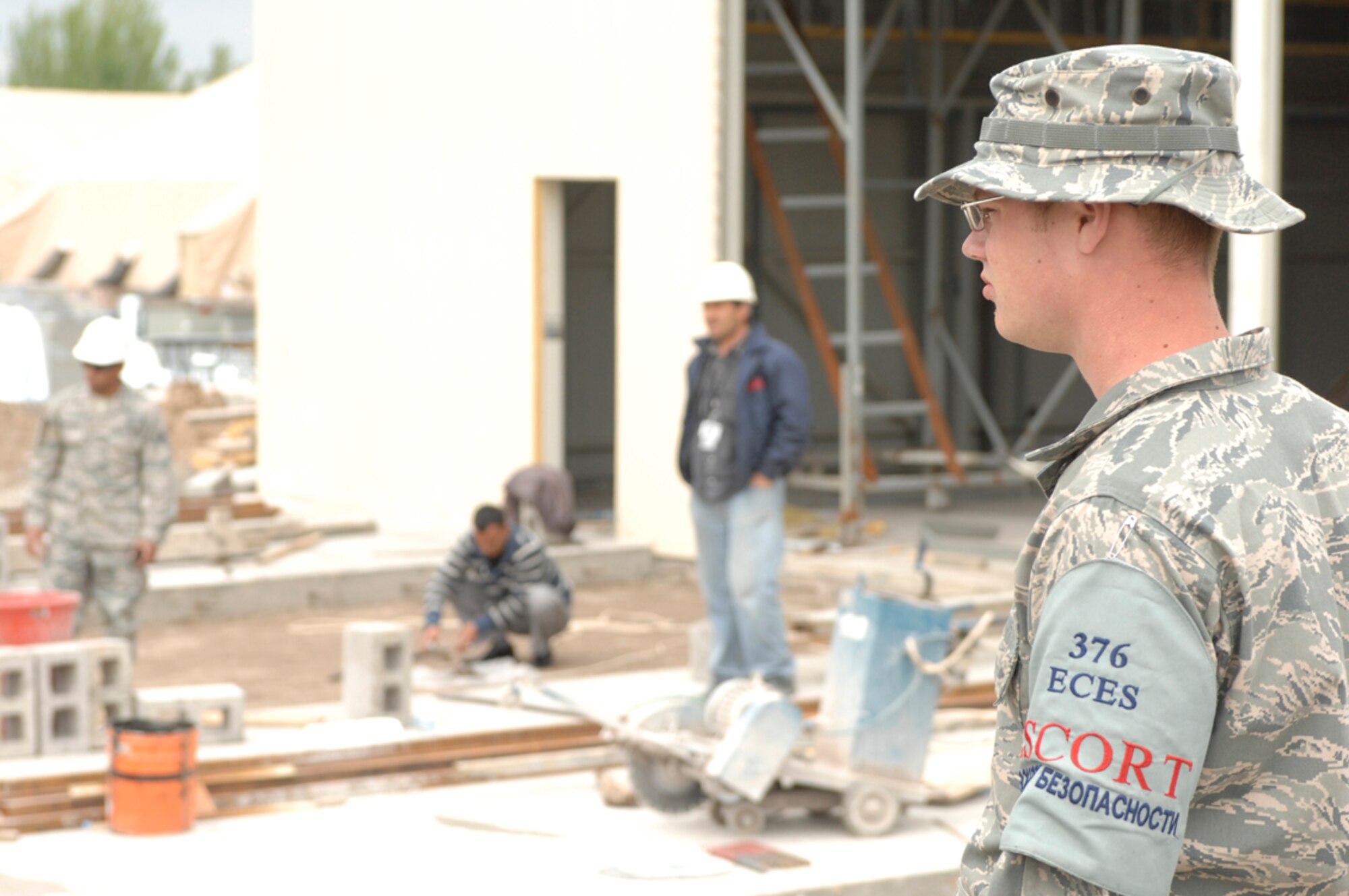 Senior Airman Theodore Smith performs escort duties for the new construction of a fire station at Manas Air Base, Kyrgyzstan, April 27. While deployed, Airman Smith is assigned to the 376th Expeditionary Civil Engineer Squadron and is responsible for observing host nation contractors and employees that work on base. He is deployed from Elmendorf Air Force Base, Ala., and is a native of Chapin, S.C. (U.S. Air Force photo/Master Sgt. Charles M. Wade) 