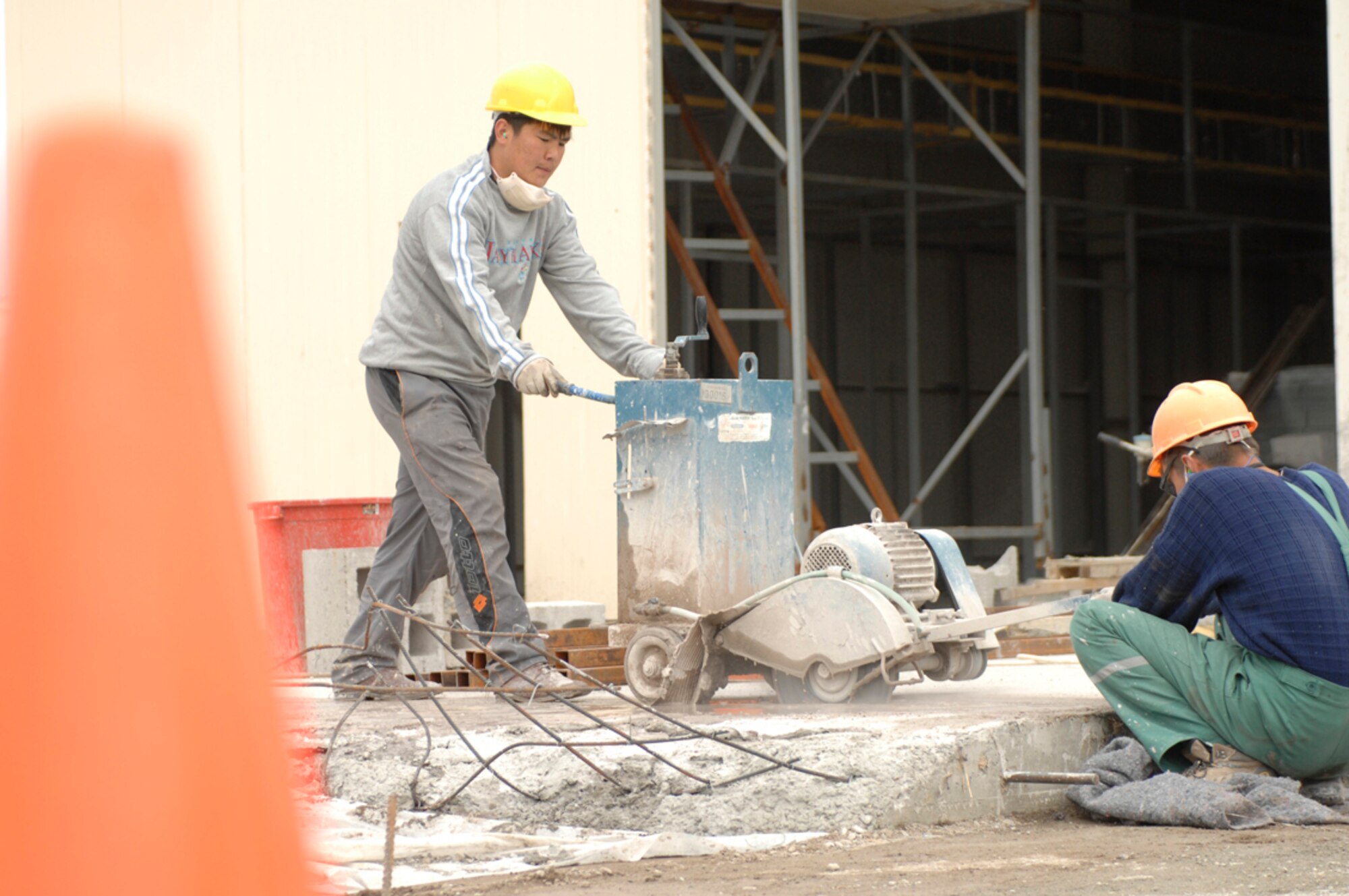 Kyrgyz construction workers cut concrete at a construction site for a new fire station at Manas Air Base, Kyrgyzstan, April 27. The fire station is projected to be complete around May 15 and will replace a tent station that has been used for more than seven years. It will provide shelter for two trucks, offices and living quarters for firefighters on duty. (U.S. Air Force photo/Master Sgt. Charles M. Wade) 