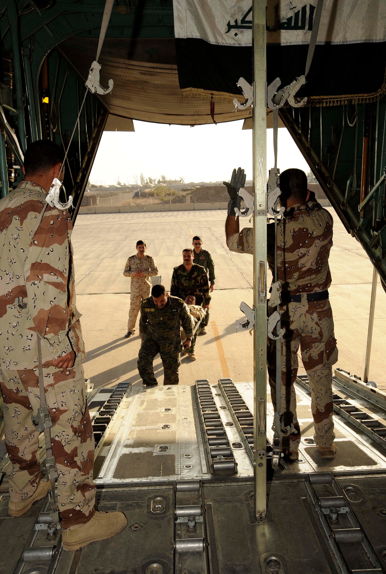 Lieutenant Tahssen marshals in a litter during the aero-medical evacuation class for the Flight Surgeon course at New al-Muthana Air Base, Iraq April 20, 2009. The training is teaching the Iraqis how to convert a UH-1 Huey Helicopter and a C-130 Hercules Aircraft from a passenger transport to an aero-medical evacuation medevac transport. This is the third class of Iraqi flight surgeons that will be graduating from the four week course.  The course, which is currently taught by Iraqi flight surgeons and the Coalition Air Force Training Team will be 100 percent taught by the Iraqis during the next course.  After completing the course the Iraqi officers are going to be responsible for doing physicals on candidates that want to fly in the Iraqi forces and taking care of the current aircrew members. Lieutenant Tahssen is a flight nurse at New al-Muthana Air Base clinic.   (U.S. Air Force photo by Senior Airman Jacqueline Romero)