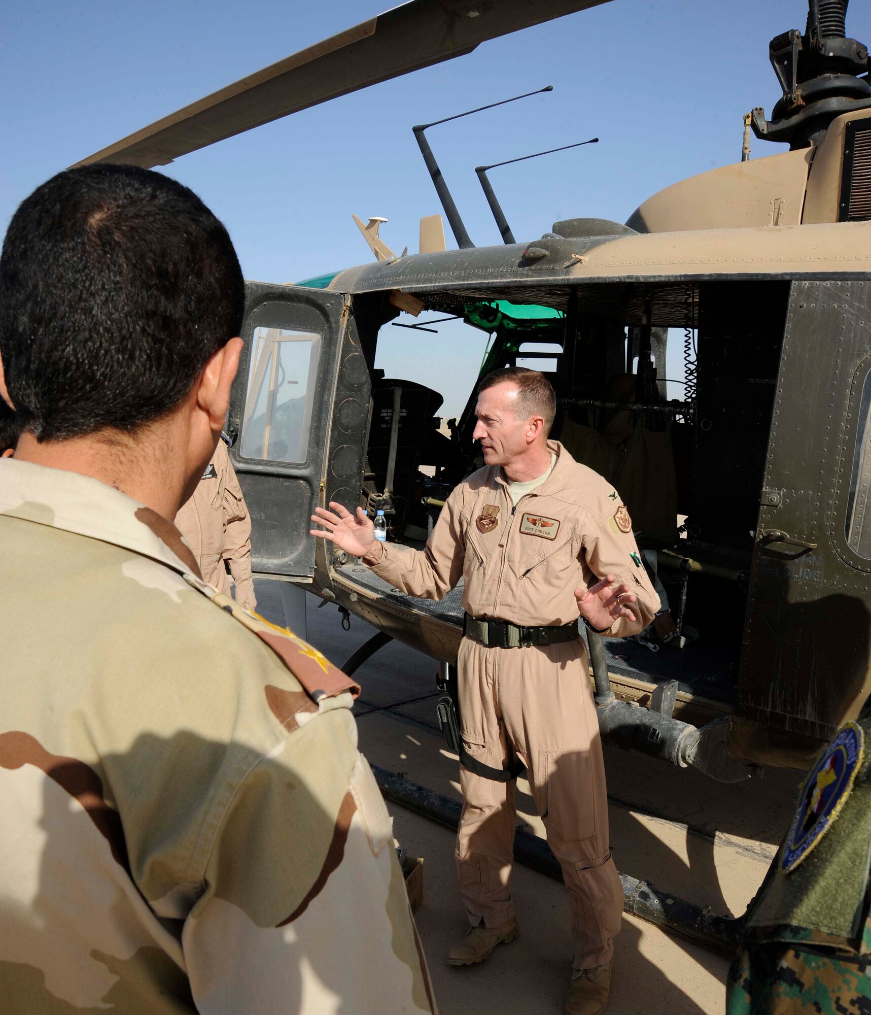 Col. William Dodson, Coalition Air Force Training Team, advises seven Iraqi air force and Iraqi army physicians during the aero-medical evacuation class at the flight surgeon course at New al-Muthana Air Base, Iraq April 20, 2009.  The training is teaching the Iraqis how to convert a UH-1 Huey Helicopter and a C-130 Hercules Aircraft from a passenger transport to an aero-medical evacuation medevac transport. This is the third class of Iraqi flight surgeons that will be graduating from the four week course.  The course, which is currently taught by Iraqi flight surgeons and the Coalition Air Force Training Team will be 100 percent taught by the Iraqis during the next course.  After completing the course the Iraqi officers are going to be responsible for doing physicals on candidates that want to fly in the Iraqi forces and taking care of the current aircrew members.  Colonel Dodson is deployed from McGuire Air Force Base, N.J. and a native to Harrisburg, Pa.  (U.S. Air Force photo by Senior Airman Jacqueline Romero)