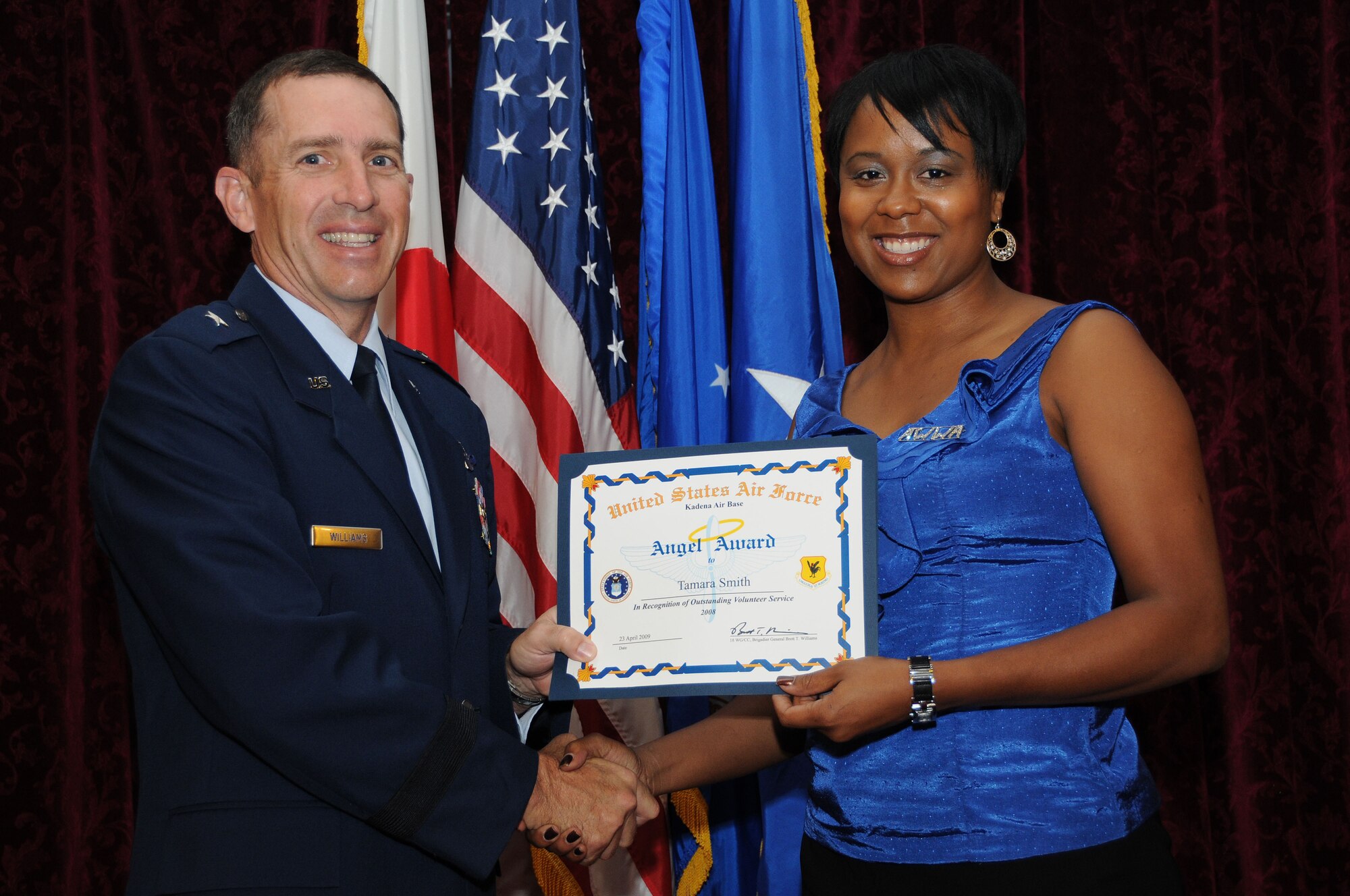 Mrs. Tamara Smith, from the Kadena Officers Spouses Club, is presented the Category 3- Family Member Angel Award during the Annual Volunteer Recognition Ceremony at Kadena Air Base April 23. 
(U.S. Air Force photo/Staff Sgt. Darnell Cannady)