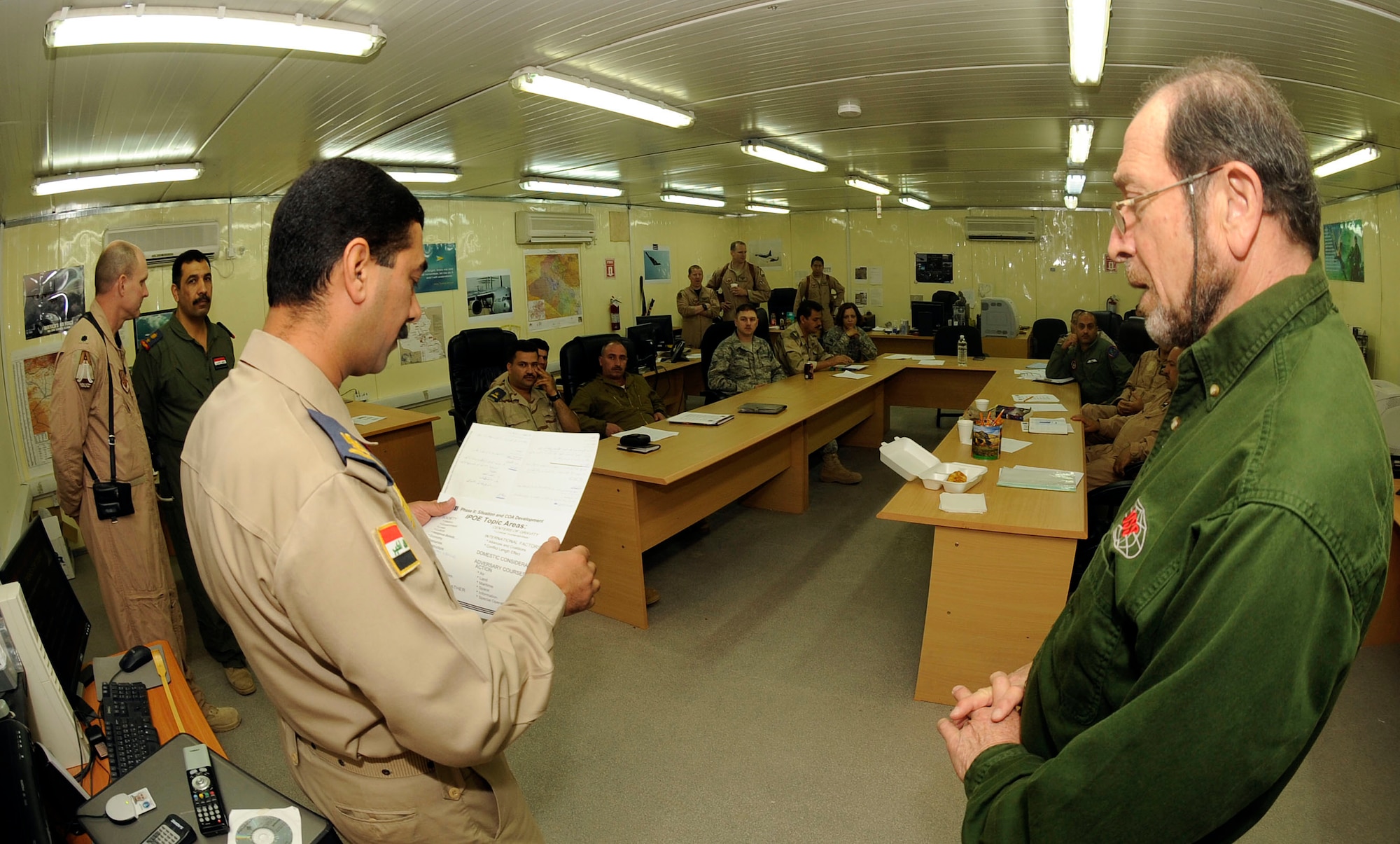 Coalition Air Force Training Team Airmen come together to teach the U.S. Joint Air Operations Planning course for the first time to Iraqi airmen at Camp Victory, Iraq April 21, 2009. Ten members of the Iraqi air force learn about planning operational-level air operations, which will further help the Iraqi air force Air Operations Center improve its operational effectiveness.  After course completion, the Iraqi officers are going to write the first Iraqi air operations plan. The course is also taught in a two week curriculum at Maxwell-Gunter Air Force Base, Ala. (U.S. Air Force photo by Senior Airman Jacqueline Romero)