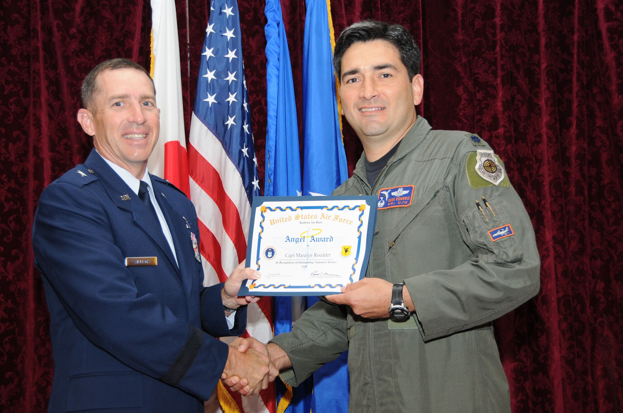 Lt. Col. Rene Romero, 961st Airborne Air Control Squadron Commander, accepts the Category 1-Active Duty Angel Award on behalf of winner Capt. Maralyn Roedder, also from the 961st AACS, during the Annual Volunteer Recognition Ceremony at Kadena Air Base April 23. 
(U.S. Air Force photo/Staff Sgt. Darnell Cannady)