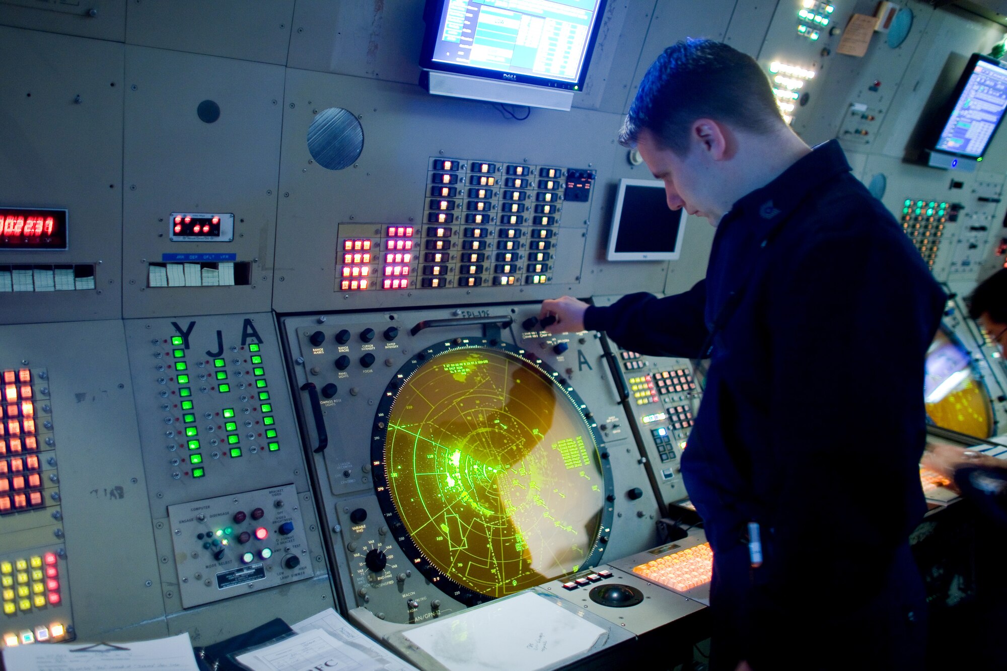 YOKOTA AIR BASE, Japan -- Tech. Sgt. George Brown, 374th Operations Support Squadron air traffic control senior watch supervisor, monitors air traffic at the base's radar approach control facility. Radar approach control facility and tower personnel will move to a new facility in November. Workers are currently setting up new equipment in the facility, which replaces a control tower and RAPCON in use since the 1960s. (U.S. Air Force photo/Osakabe Yasuo)