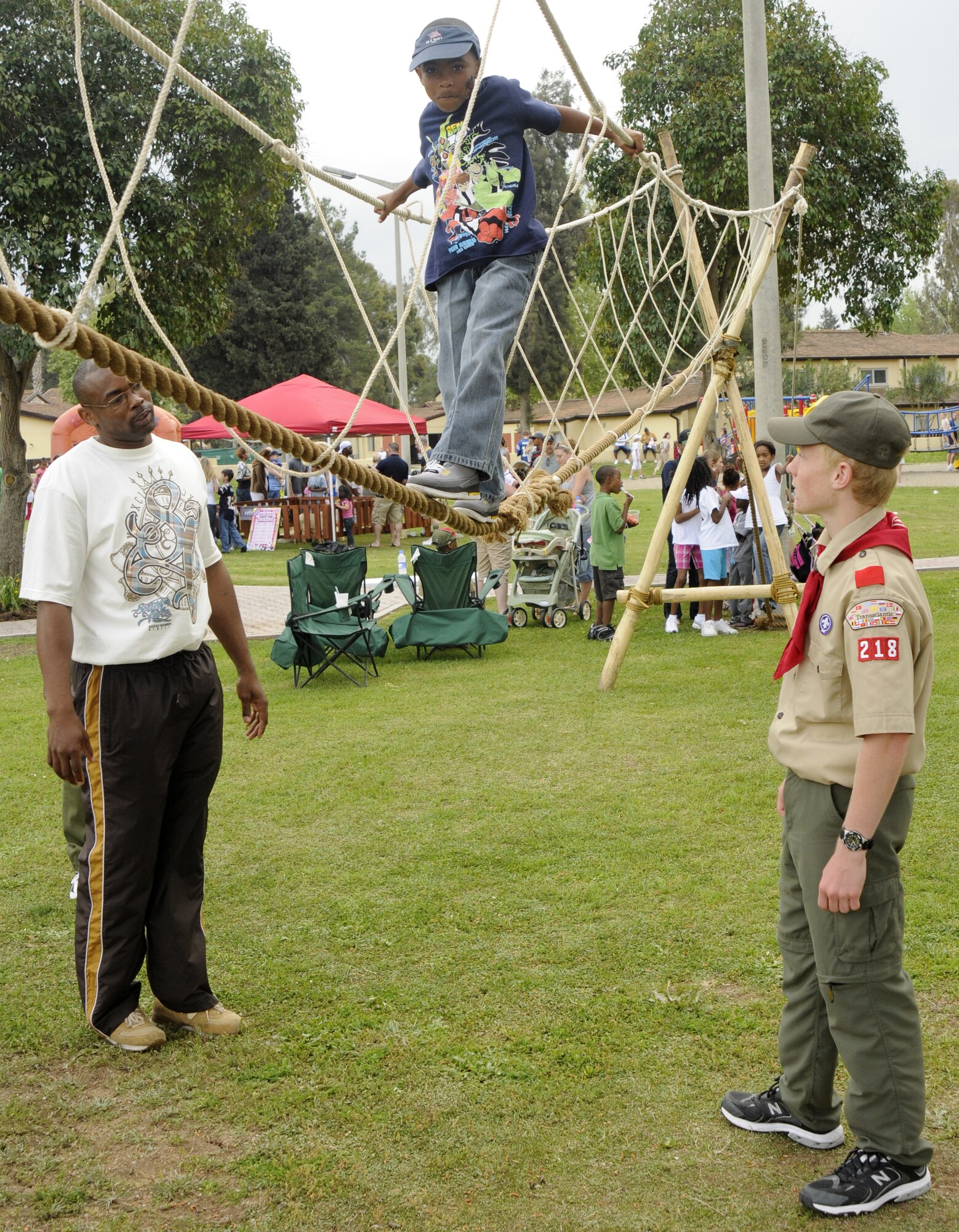 Jordan is looked after by his father Tech Sgt. Jonathan Byrd, 728 AMS, and Boy Scout Nick Pelkey, son of Major Kyle Pelkey, 39th Medical Operation squadron, as he walks the hand-made rope bridge April 25, 2009 at Incirlik’s Spring Fling at Incirlik Air Base, Turkey. Every year, the Spring Fling is held to help celebrate the incoming warm season with at least three hundred base attendants. With food, music, crafts and children friendly events, this year’s Spring Fling also showcased the Indianapolis Colts cheerleaders.  (U.S. Air Force photo/Airman 1st Class Amber Russell)