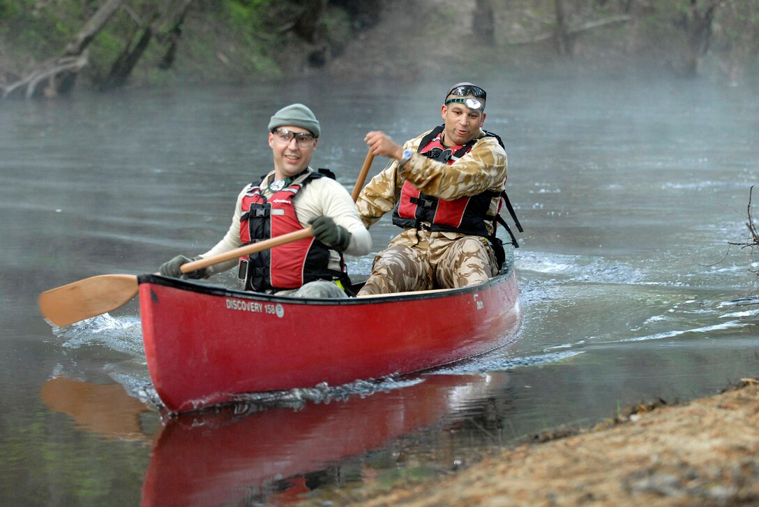 U.S. Army Capt. Jose J. Hernandez, battle captain with the operations team for 82nd Airborne Division Headquarters at Fort Bragg, N.C.,  leads the paddling in a canoe with his teammate, British Army Capt. Ben Salt, attached to "The Team," to the river bank of Fort Bragg's Little Creek on April 23, 2009, during a customized morning physical training session called "adventure PT." U.S. Army photo by Spc. Ben Watson, 49th Public Affairs Detachment (Airborne)